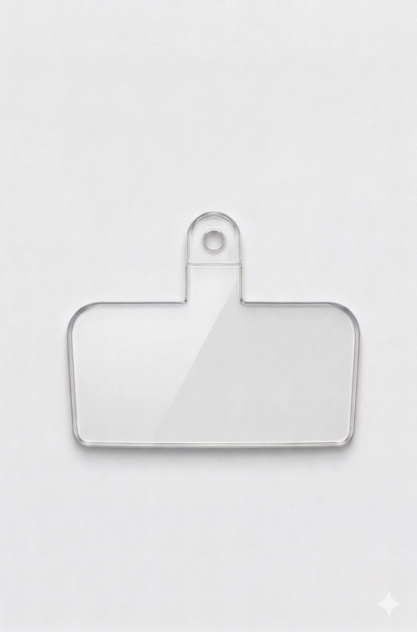 Clear plastic patch on a white background compatible with all phone cases and Charmole phone straps