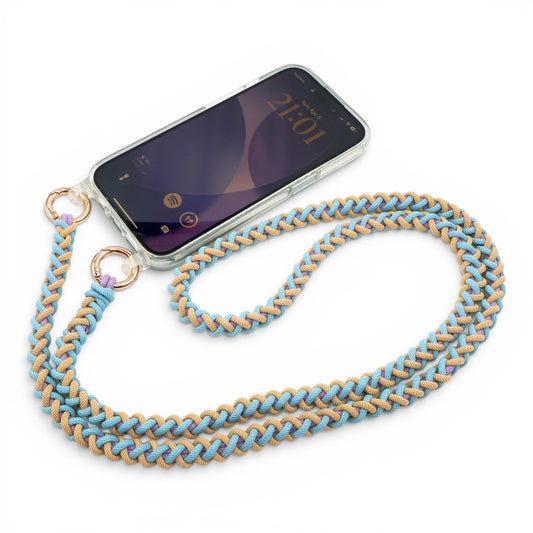 Phone with Laguna Breeze macrame crossbody strap on a white background