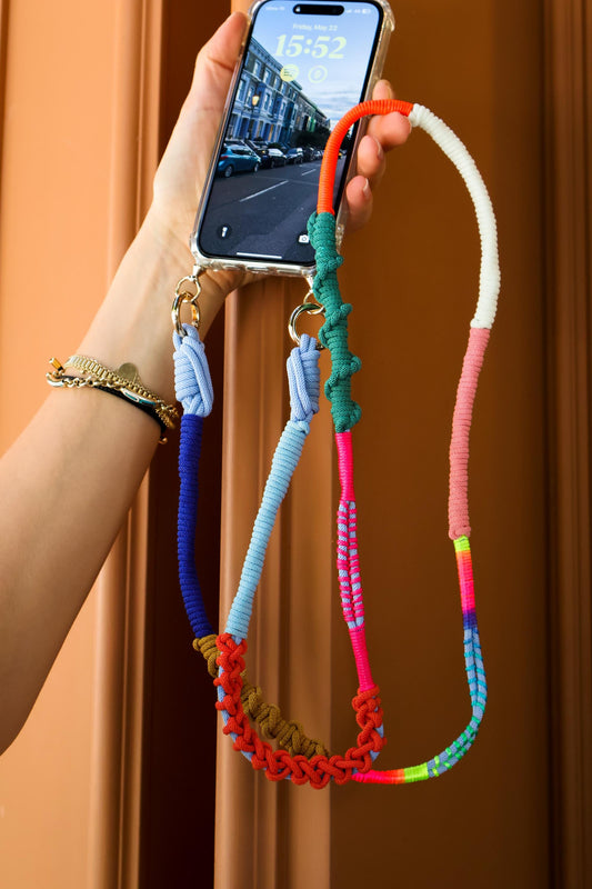Prism Coast macrame crossbody strap held in the air- hand-braided cord, hands-free UAE lifestyle