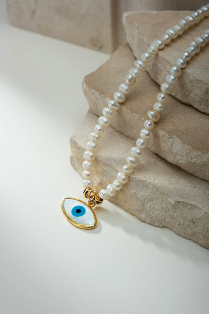 Guardian Pearl Necklace displayed on a prop