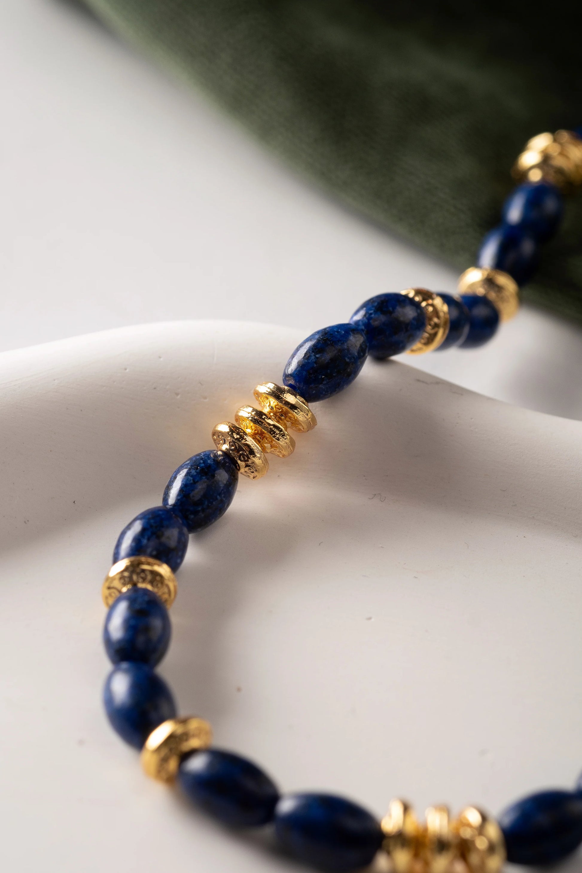 Close-up of Mirage Lapis Lazuli Necklace showing lapis lazuli stone and gold-plated finish