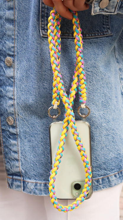 Citrus Twist macrame crossbody strap with a phone case on a denim background