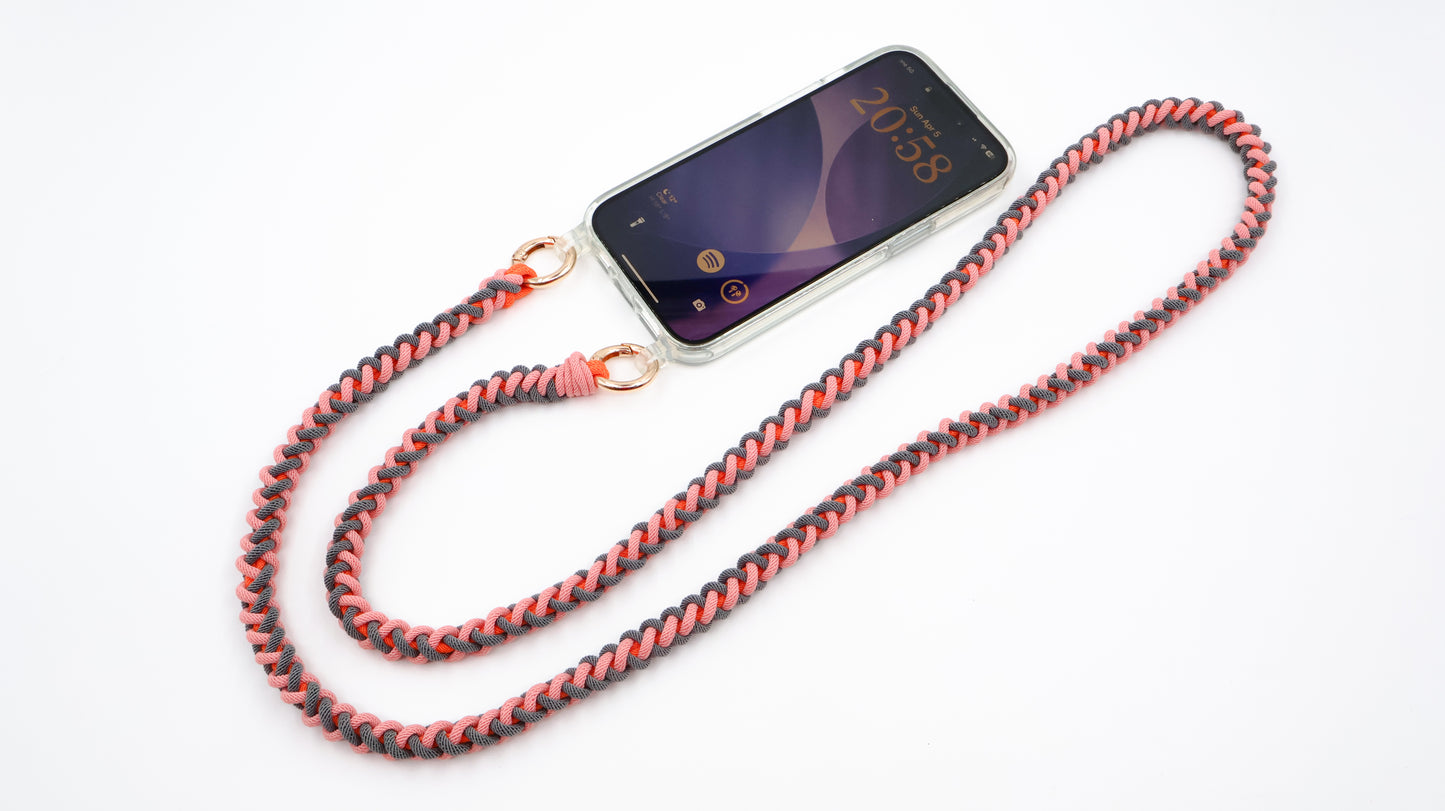 Phone case with Coral Drift macrame crossbody strap on a white background