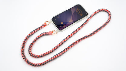 Phone case with Coral Drift macrame crossbody strap on a white background