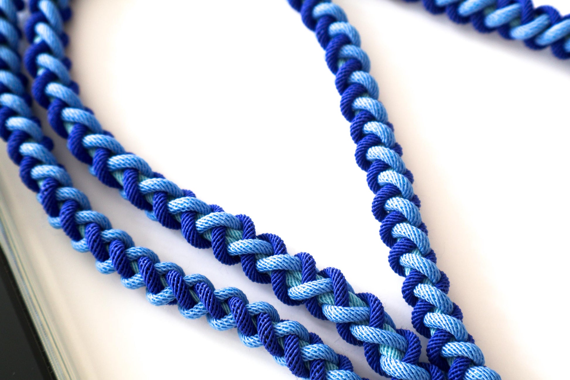 Close-up of Milan Blue crossbody strap on a white background
