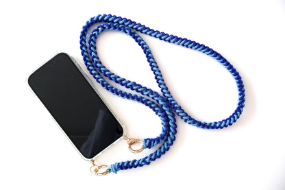 Milan Blue hand-knotted macrame crossbody strap braided phone lanyard with a black smartphone on a white background