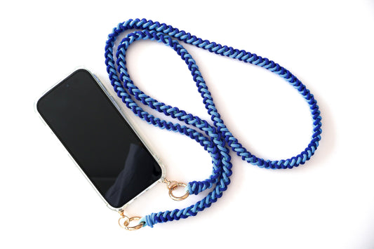 Milan Blue hand-knotted macrame crossbody strap braided phone lanyard with a black smartphone on a white background